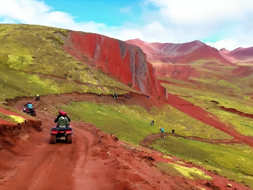Wide shot of Red Valley’s deep crimson terrain under the bright blue sky