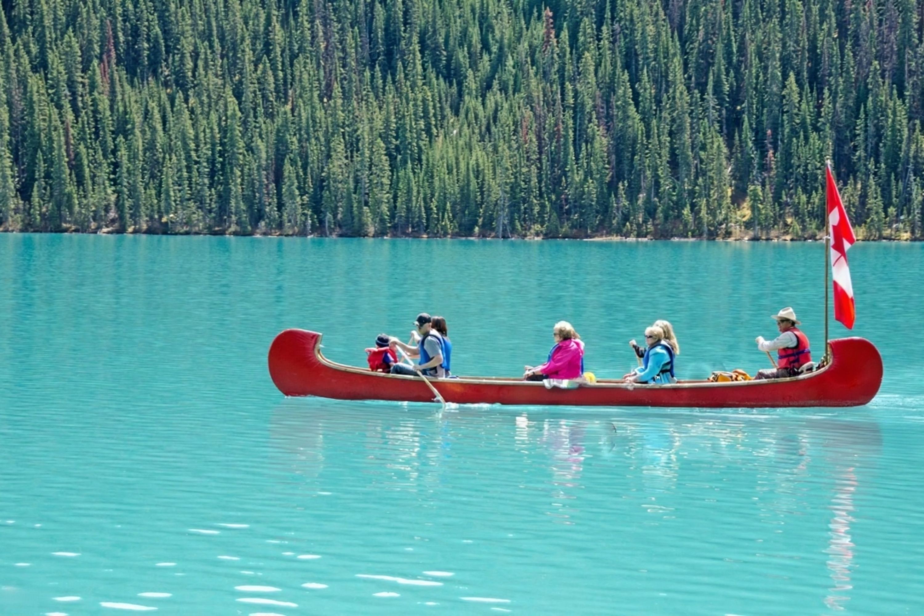 Lake Louise shines with turquoise waters surrounded by soaring peaks in Banff