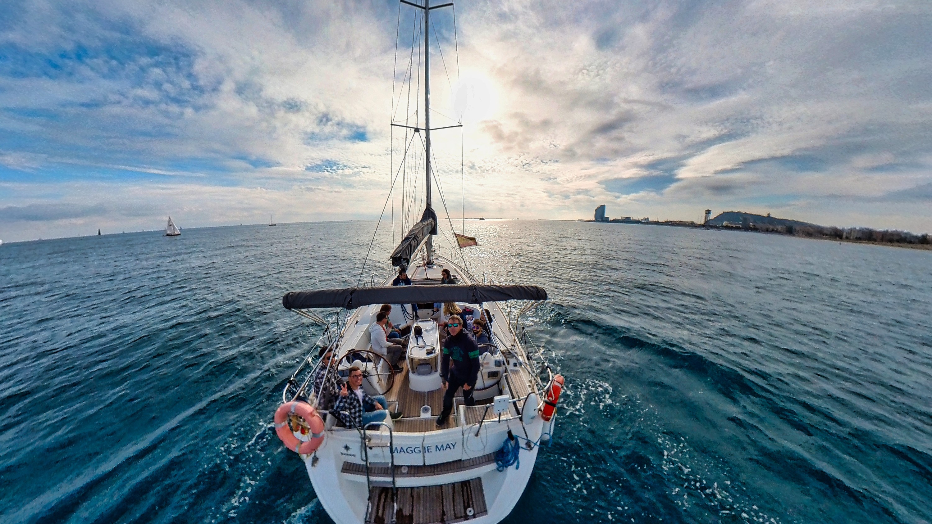 Guests relax and laugh together as the boat glides gently across the calm Mediterranean Sea