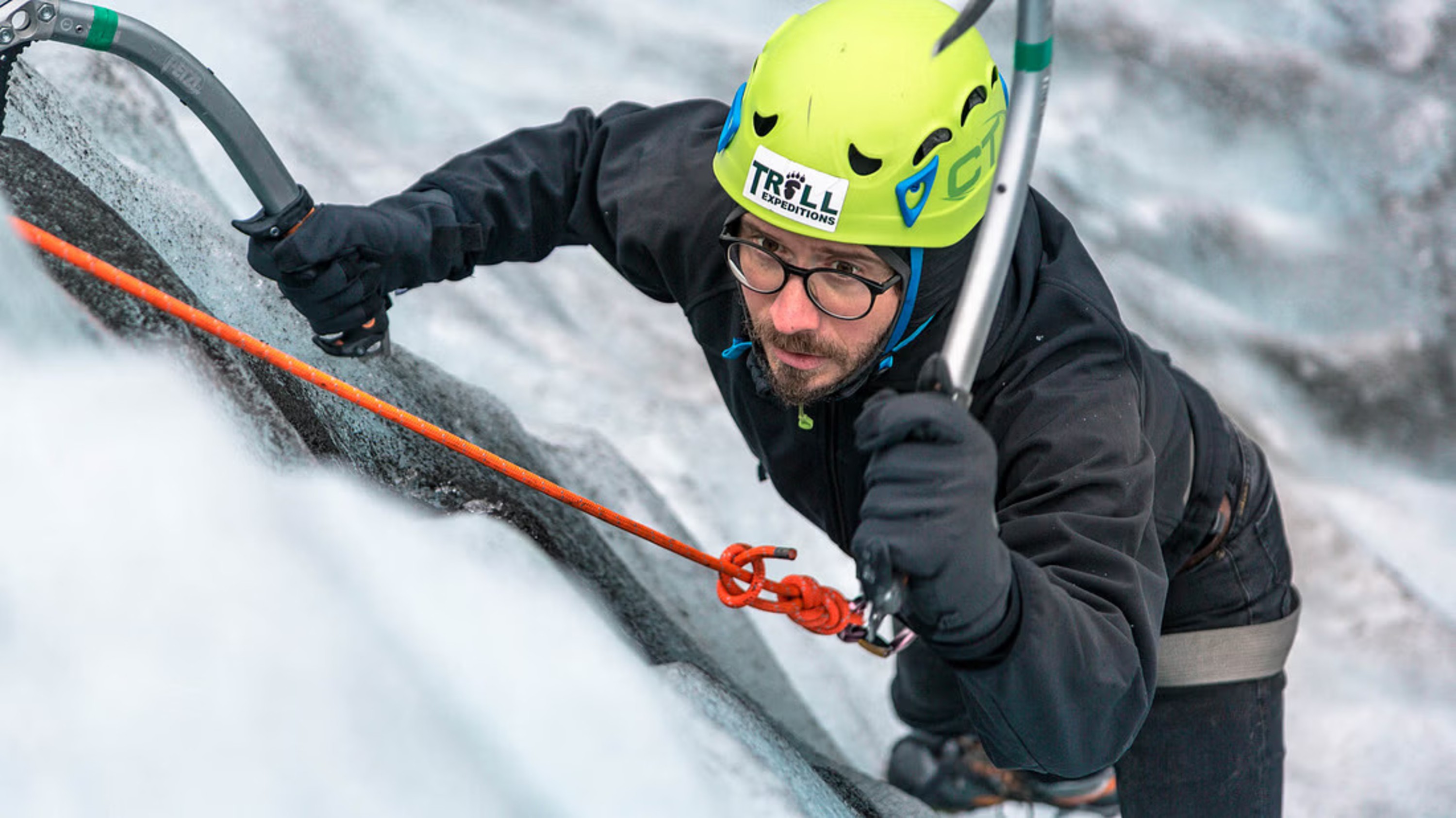 With ice axes in hand, climbing the towering ice wall becomes an exciting challenge!