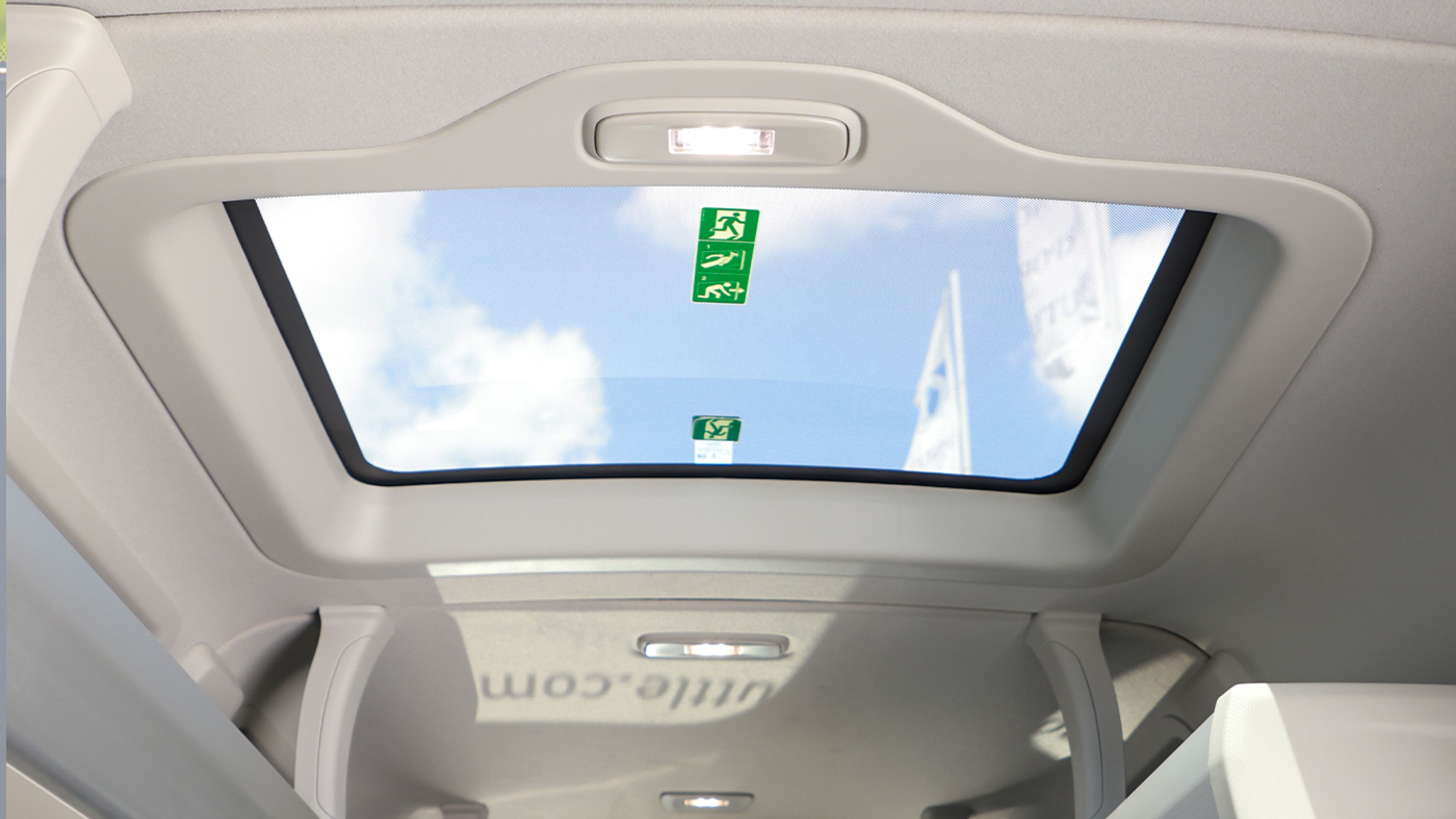 A large sunroof is overhead, letting in natural light and brightening the vehicle interior