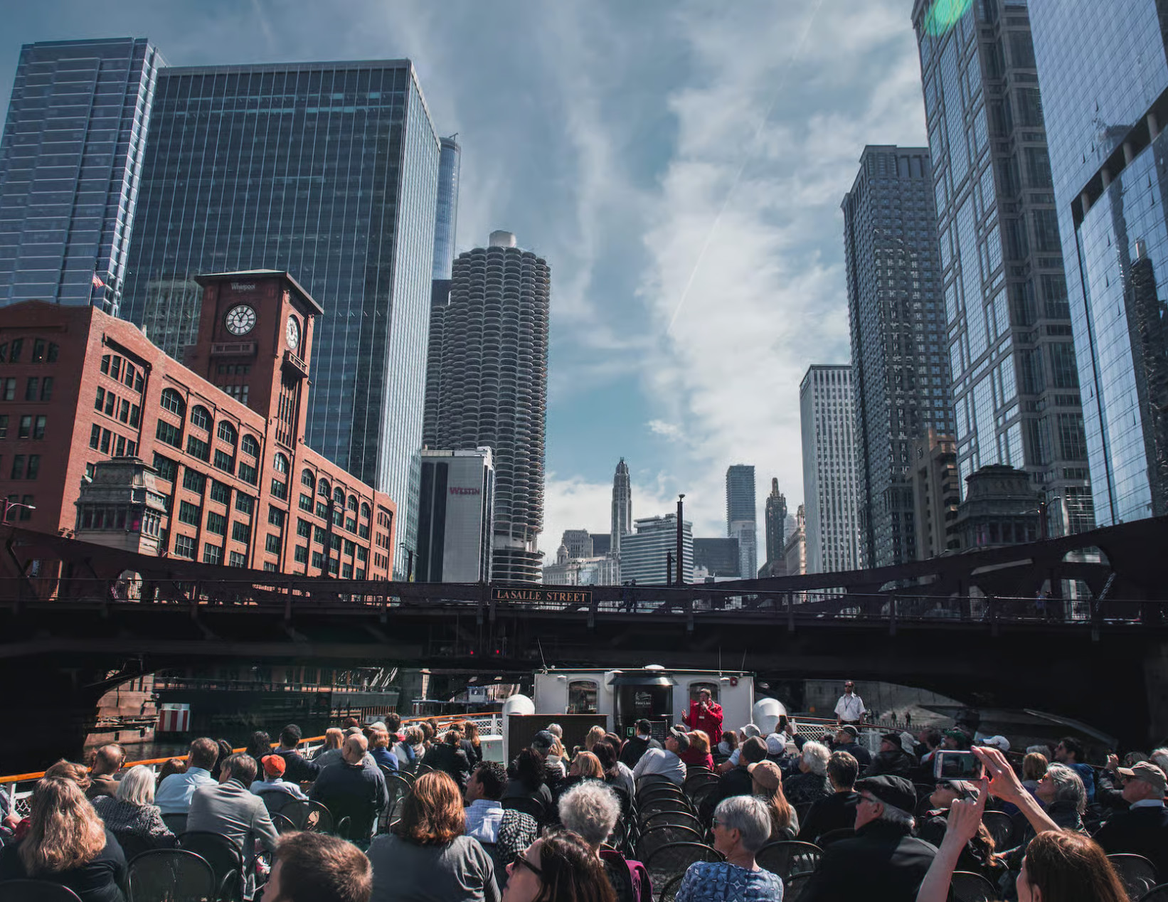Calm river scene with passing boat and Chicago’s iconic buildings in background