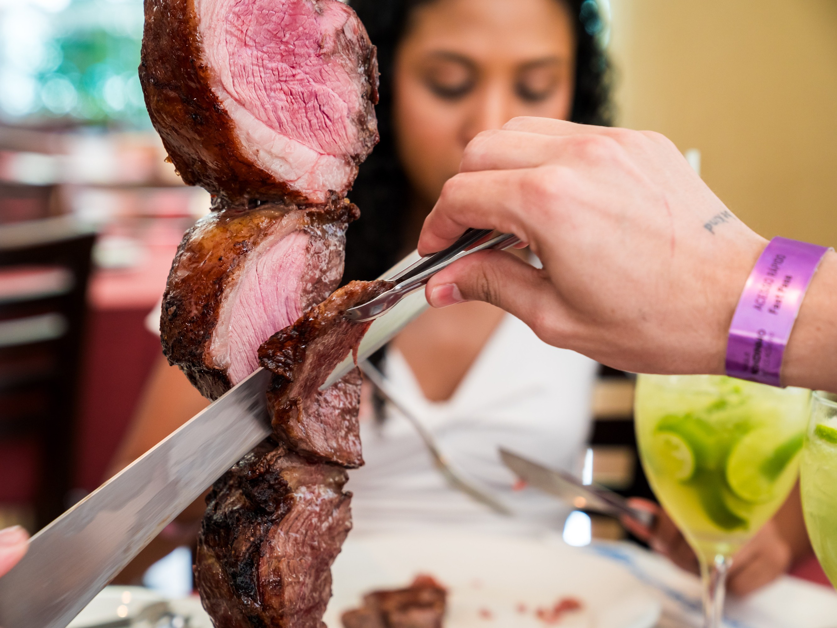 Plates of grilled meats and sides at a traditional Rio churrascaria lunch