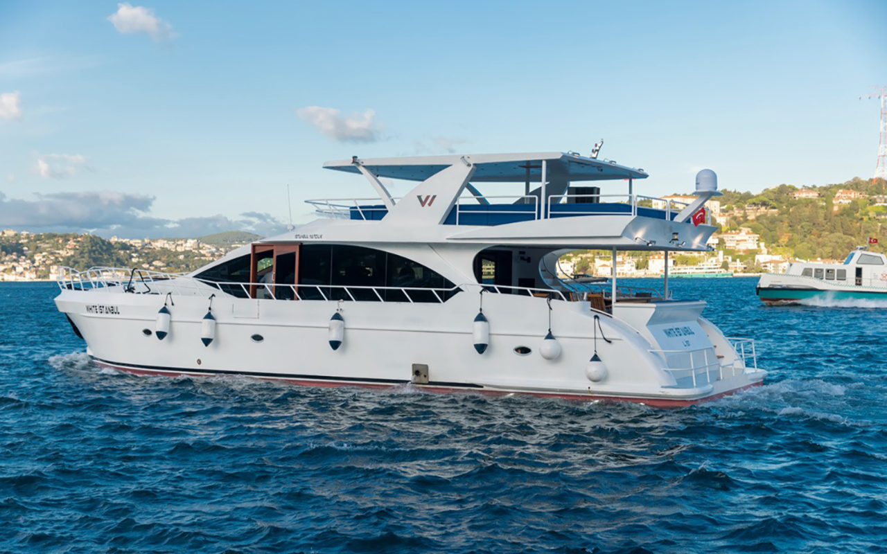 Sunset over the Istanbul skyline seen from an elegant private yacht returning home slowly