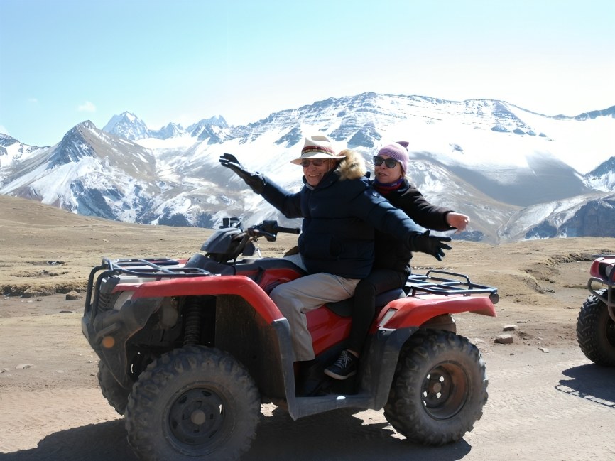 Guest snapping panoramic shot of Ausangate’s peaks under clear, cloudless blue skies
