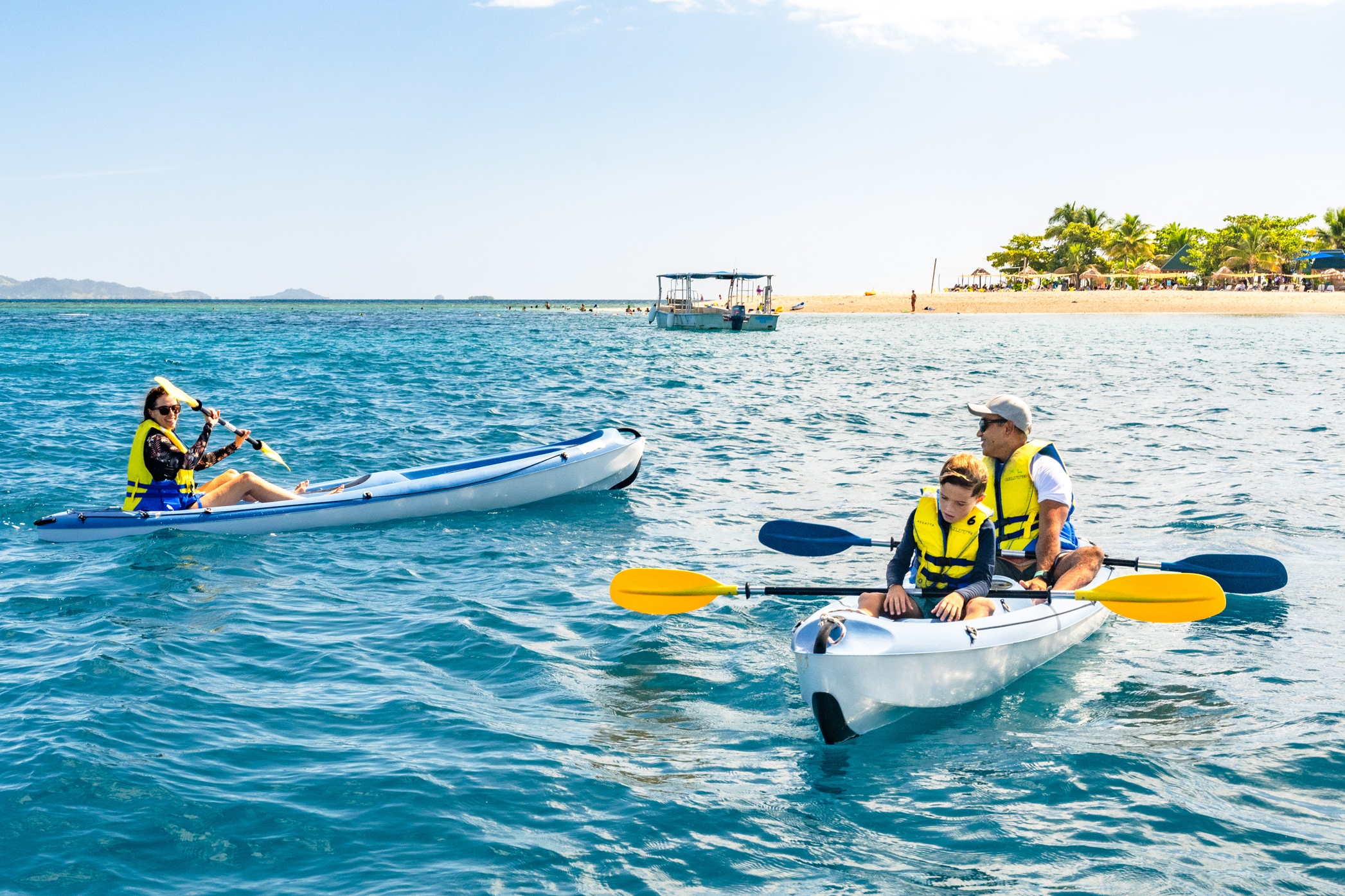 Paddle your kayak gently across calm lagoons, embracing South Sea Cruises’ scenic journey