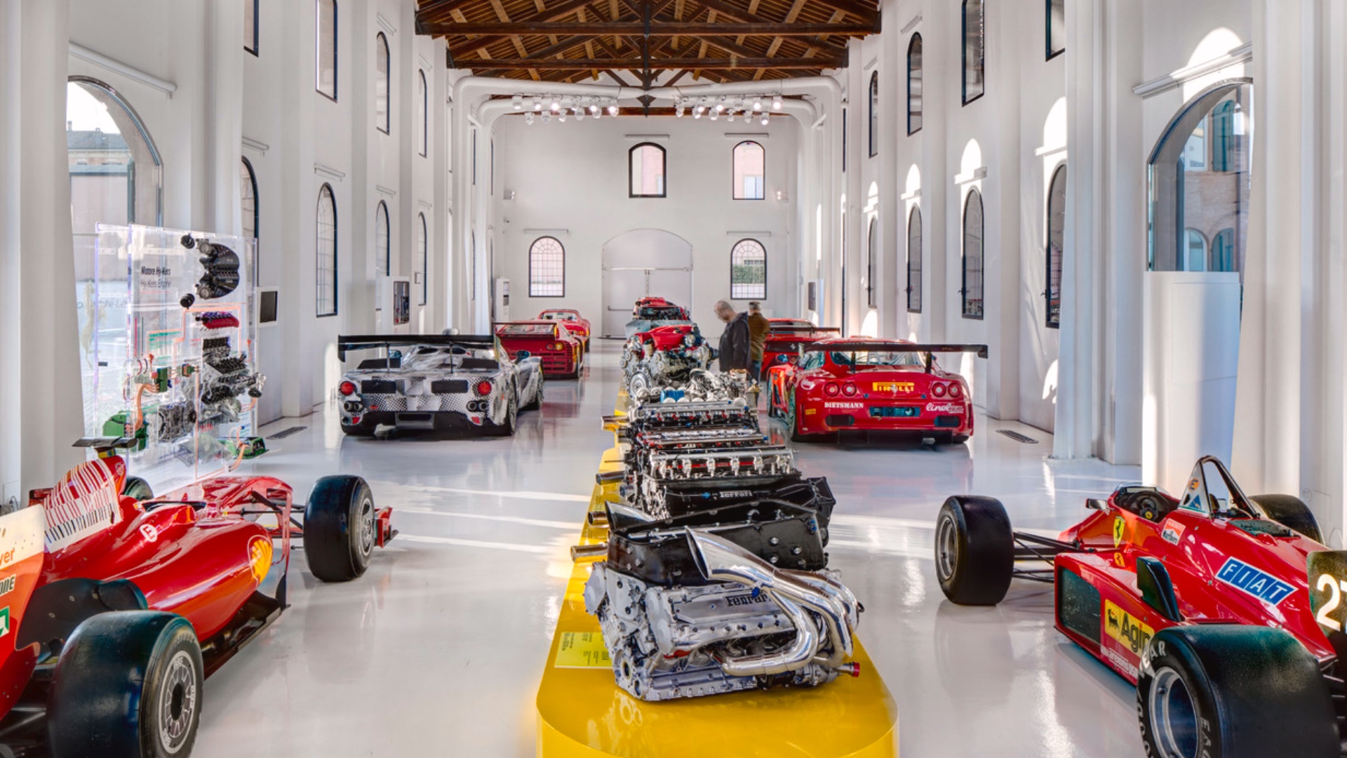 A display of Ferrari racing engines and legendary models inside the sleek, modern Ferrari Museum