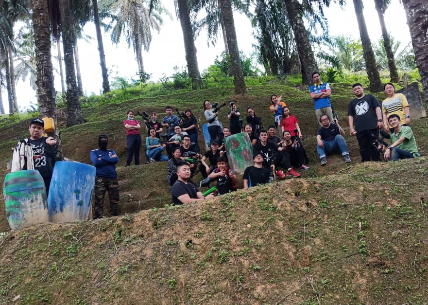 Group of men and women posing for the camera on the small hill