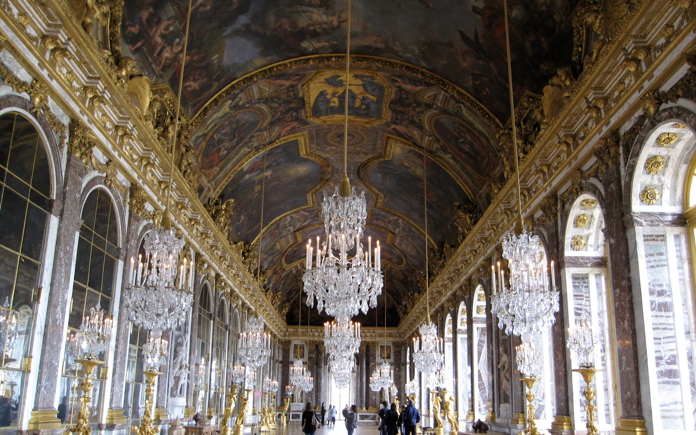 Glittering Hall of Mirrors reflecting chandeliers and arched windows