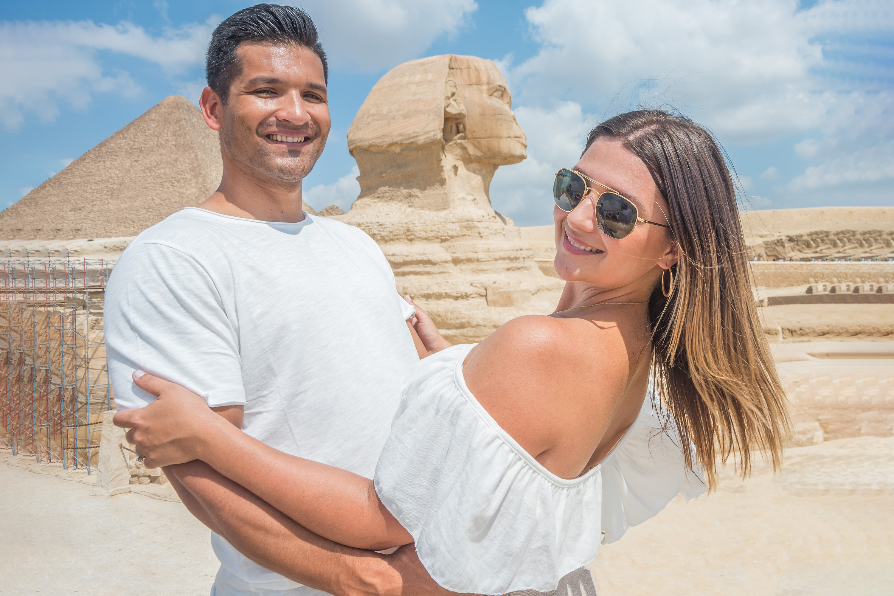 Smiling couple at the Pyramids and the Sphinx view