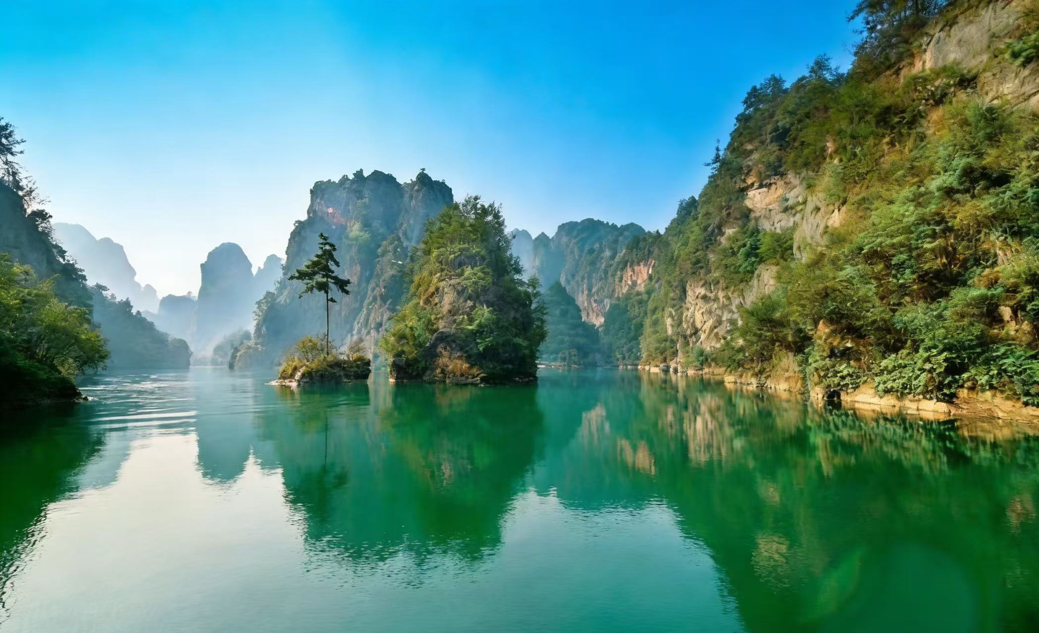 After lunch, continue your trip to Baofeng Lake. Enjoy a boat trip to appreciate strange-shaped stone hills and hear the melodious folk song sung by local youth before heading back to your hotel.