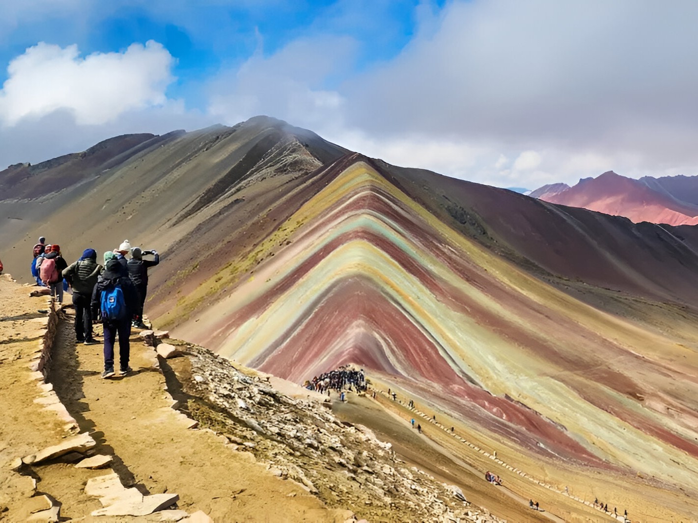 Hikers starting the ascent surrounded by rugged terrain and crisp highland air