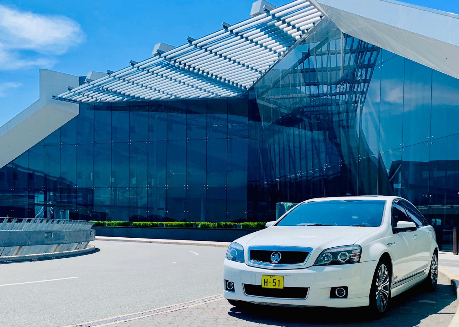 white car and building facade