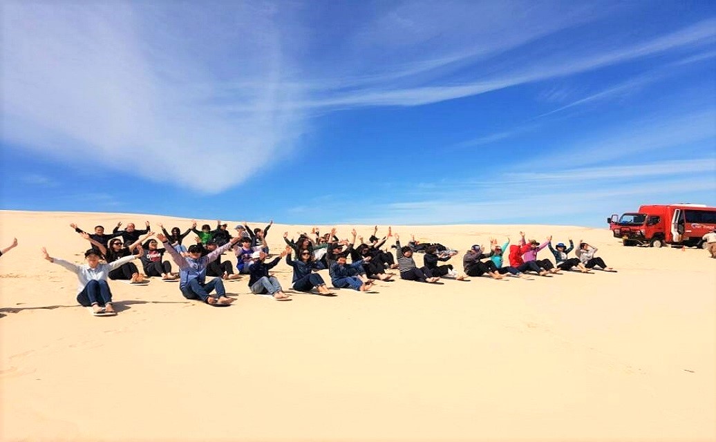 tourists on sandboard