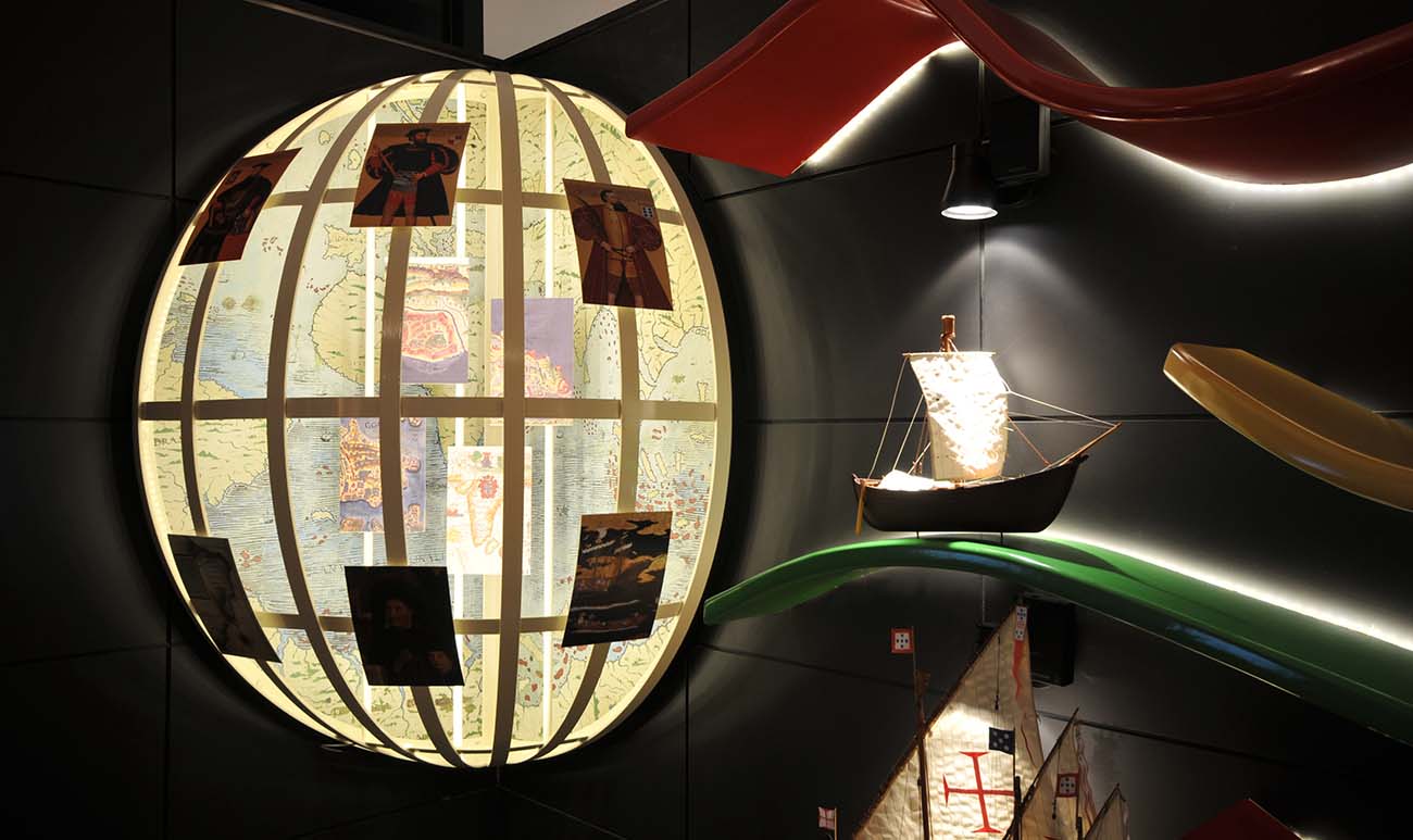 a giant globe with miniature boat