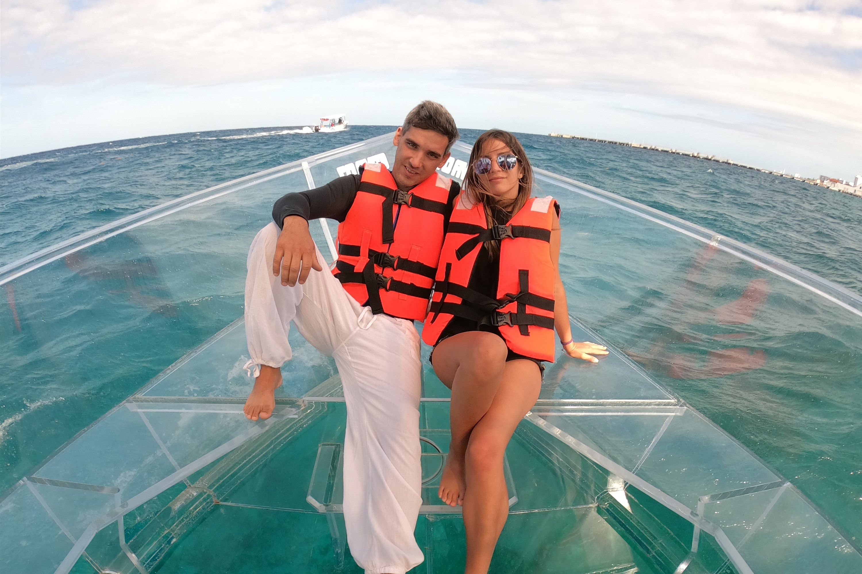 Couple enjoying a day of adventure aboard the transparent boat