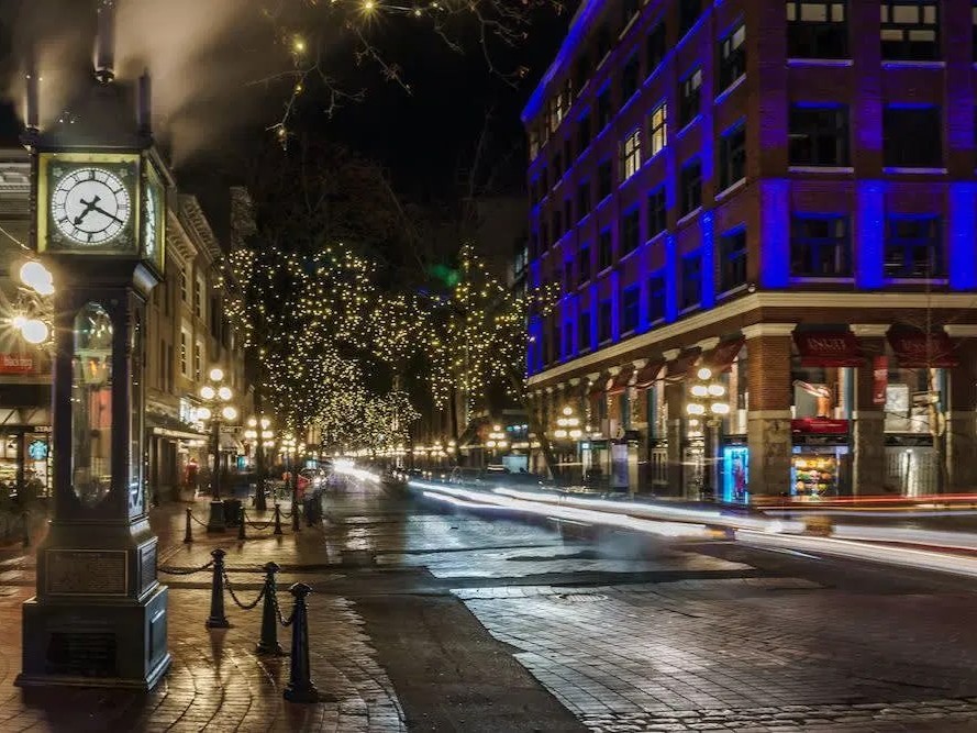 Stroll through historic Gastown and see the steam clock glowing among twinkling cobblestone streets