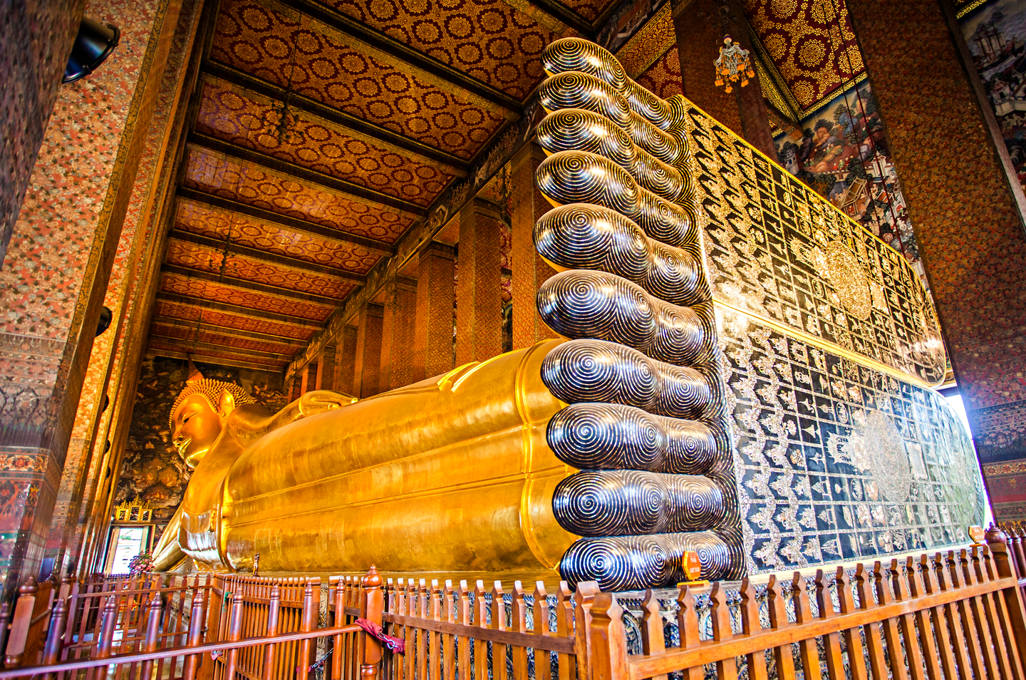 Marvel at the massive 46-meter-long Reclining Buddha statue, covered in gold leaf, which is one of Bangkok's most