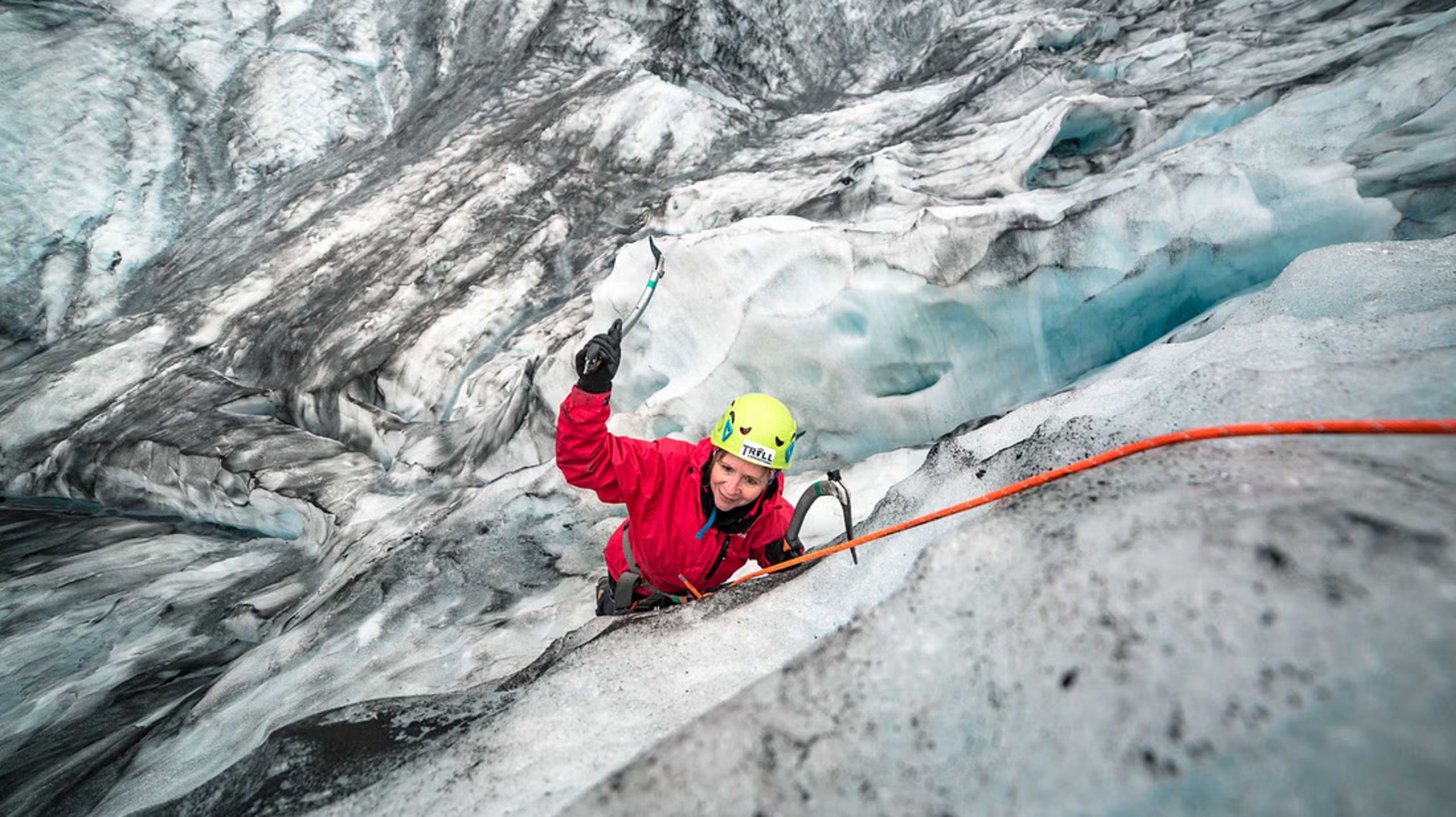 A solo adventurer explores a stunning glacier, surrounded by sparkling ice and epic views