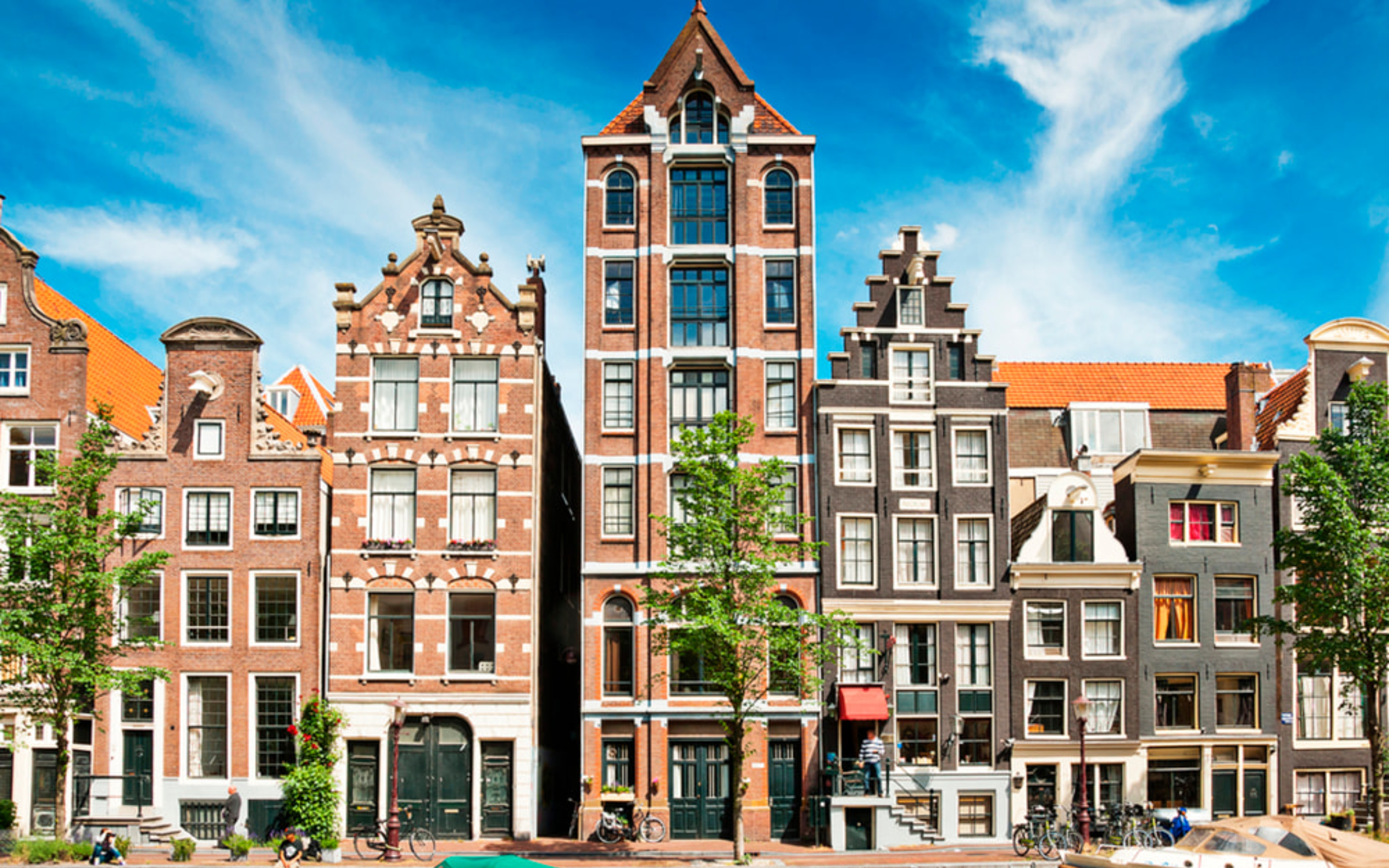 Charming canal houses with gabled roofs showcase Amsterdam’s timeless architecture and vibrant atmosphere