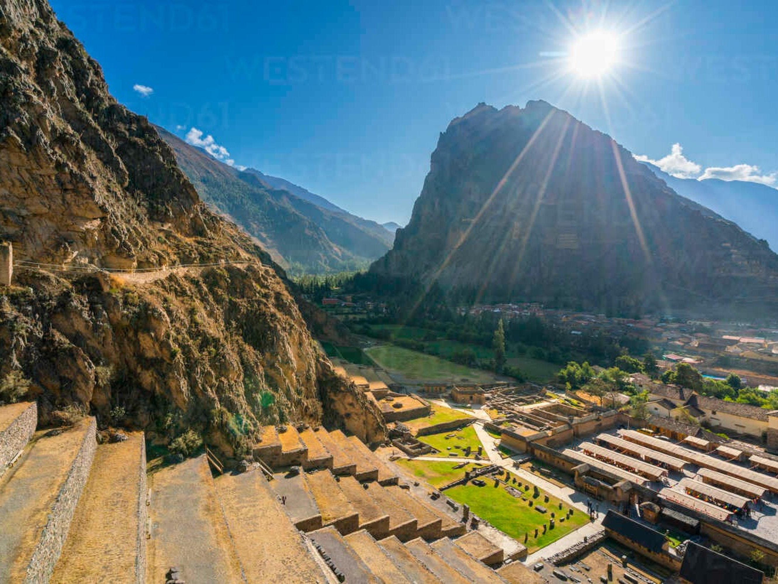 In Ollantaytambo, towering stone walls echo Inca brilliance against a rugged valley backdrop