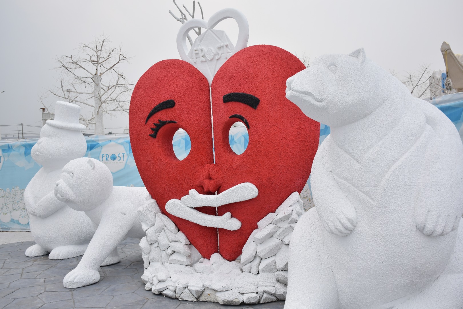 2 bear sculptures with a heart in the middle