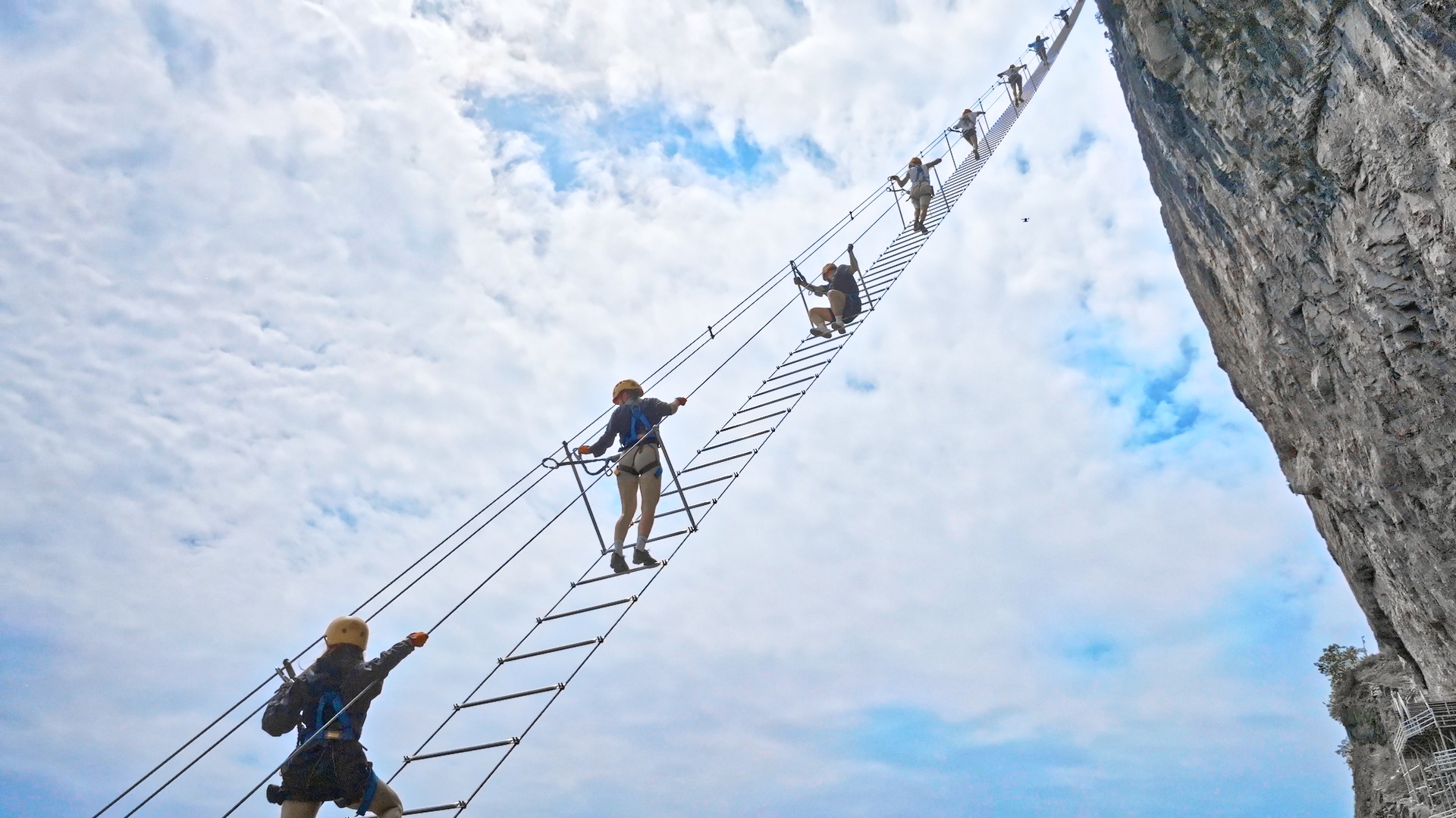 極具挑戰性的懸崖天梯(飛拉達天梯)項目,這個項目是七星山網紅探險打卡點之一,讓遊客在高空懸崖間體驗 “步步驚心” 的探險樂趣,同時將壯闊山景與雲海藍天盡收眼底。全程採用鋼索保護系統,遊客穿戴專業安全帶、頭盔,通過安全扣與主繩連接,每一步都有雙重保護,在安全的前提下盡情體驗高空探險的刺激感。項目針對不同遊客設定了難度分段,新手也能在教練指導下完成挑戰,既適合追求刺激的年輕人,也適合想突破自我的戶外愛好者。 極具挑戰性的懸崖天梯(飛拉達天梯)項目,這個項目是七星山網紅探險打卡點之一,讓遊客在高空懸崖間體驗 “步步驚心” 的探險樂趣,同時將壯闊山景與雲海藍天盡收眼底。全程採用鋼索保護系統,遊客穿戴專業安全帶、頭盔,通過安全扣與主繩連接,每一步都有雙重保護,在安全的前提下盡情體驗高空探險的刺激感。項目針對不同遊客設定了難度分段,新手也能在教練指導下完成挑戰,既適合追求刺激的年輕人,也適合想突破自我的戶外愛好者。
