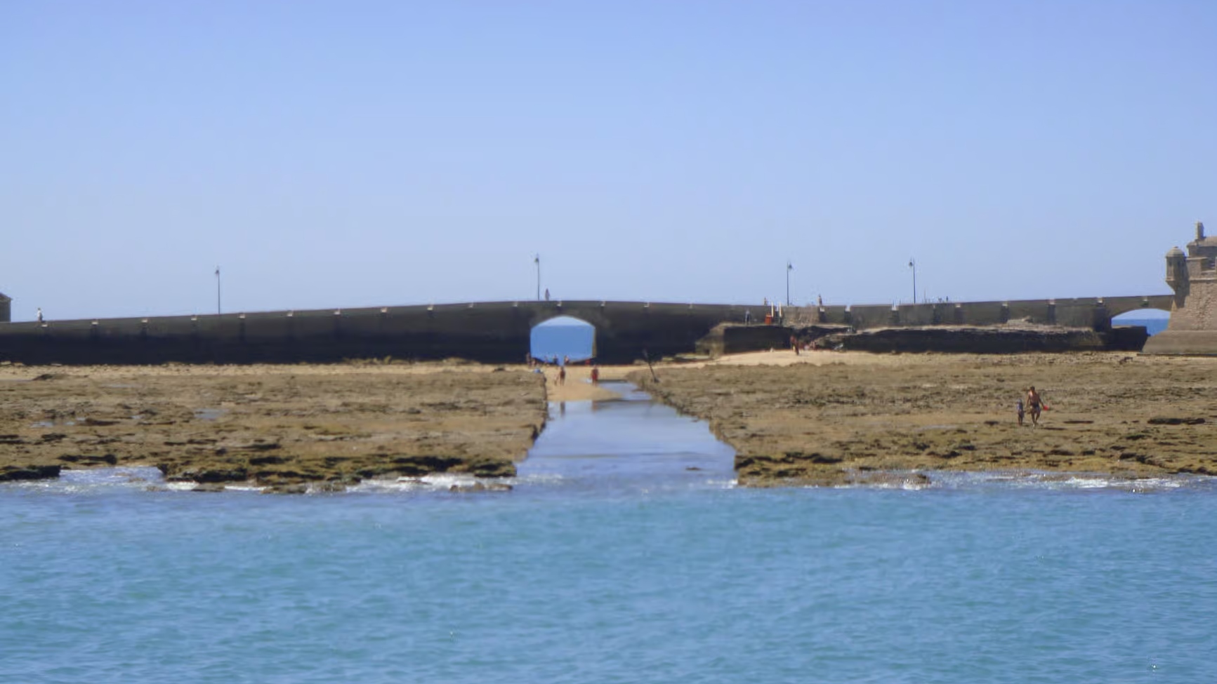 Sunlight reflecting on the bay as the catamaran glides through scenic waters