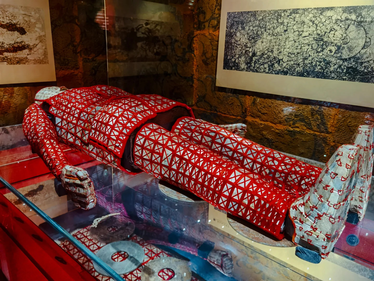 廣州南越王博物院(王墓展區)陳列的絲縷玉衣,是南越國第二代國王趙眜的喪葬殮服,為我國迄今發現年代最早、形制完備的絲縷玉衣實物。此玉衣由2291塊玉片以絲線穿綴而成,分頭套、上衣、袖筒、手套、褲筒和鞋六部分,工藝精細,玉片多呈青白色,局部呈風化現象。作為中原漢文化與嶺南本土文化融合的見證,它突破了漢代玉衣以金、銀、銅縷編綴的傳統,首次展現絲縷工藝,對研究南越國喪制、玉器文化及漢越交流具有重要價值,是南越王墓出土的鎮館之寶之一。 廣州南越王博物院(王墓展區)陳列的絲縷玉衣,是南越國第二代國王趙眜的喪葬殮服,為我國迄今發現年代最早、形制完備的絲縷玉衣實物。此玉衣由2291塊玉片以絲線穿綴而成,分頭套、上衣、袖筒、手套、褲筒和鞋六部分,工藝精細,玉片多呈青白色,局部呈風化現象。作為中原漢文化與嶺南本土文化融合的見證,它突破了漢代玉衣以金、銀、銅縷編綴的傳統,首次展現絲縷工藝,對研究南越國喪制、玉器文化及漢越交流具有重要價值,是南越王墓出土的鎮館之寶之一。