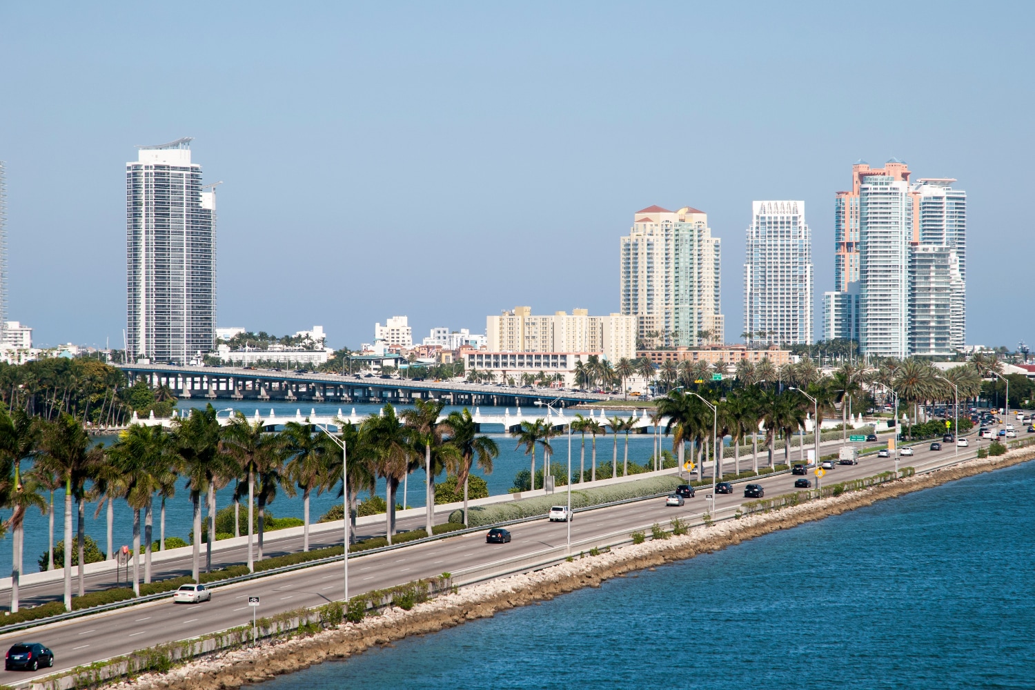 Cross MacArthur Causeway, enjoying stunning views of Miami's skyline and Biscayne Bay
