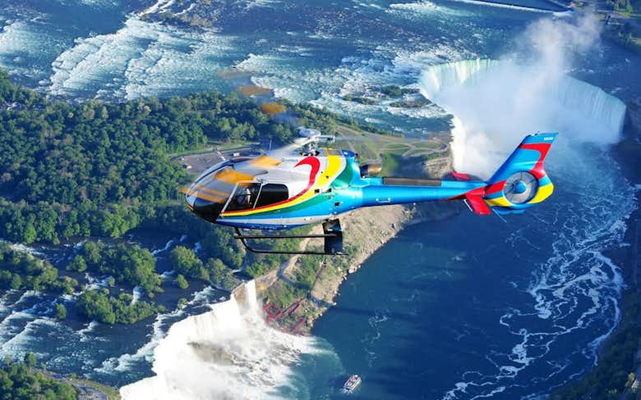 Experience the ultimate thrill as you fly directly over the roaring waters of the majestic Horseshoe Falls