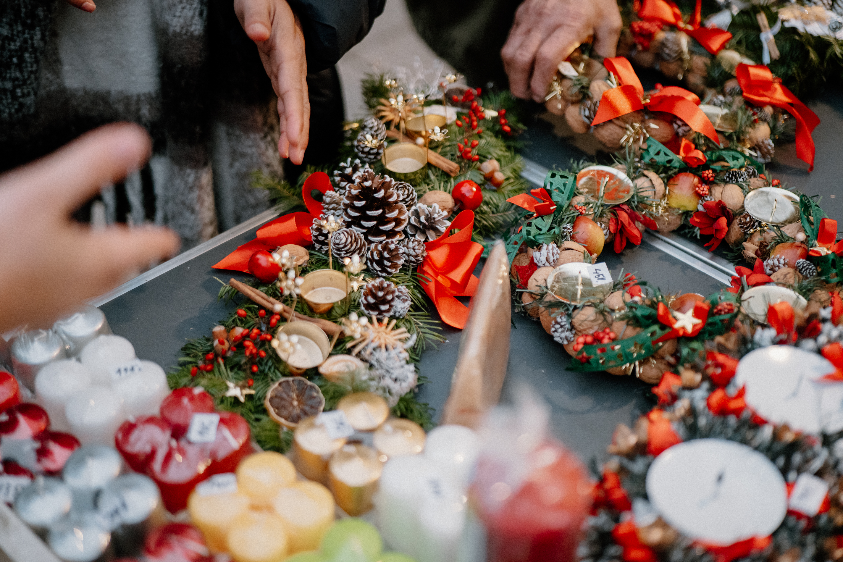 Browse stalls filled with handmade wreaths and candles, perfect for picking up unique Christmas gifts.