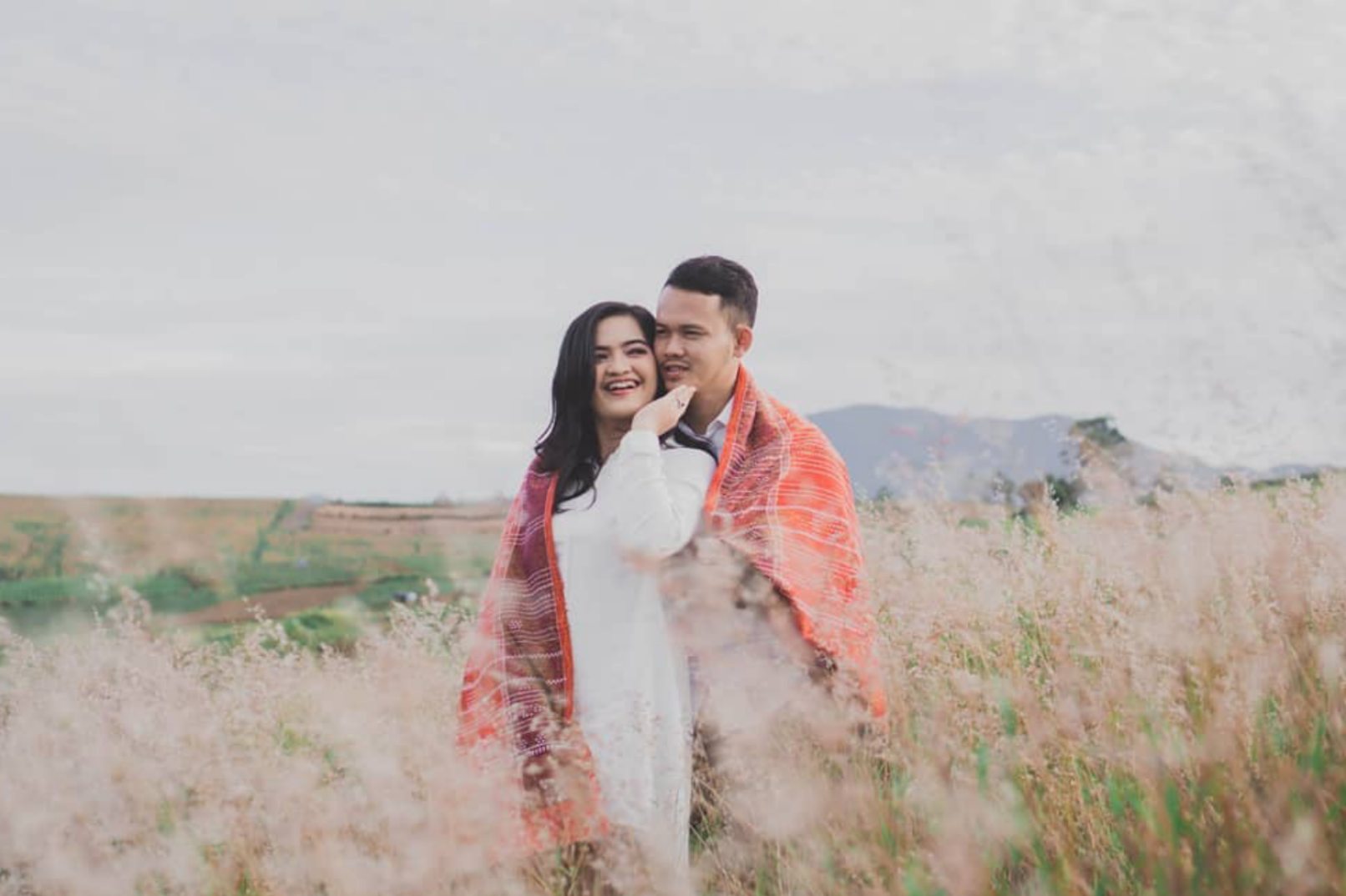 Man and woman standing in a field