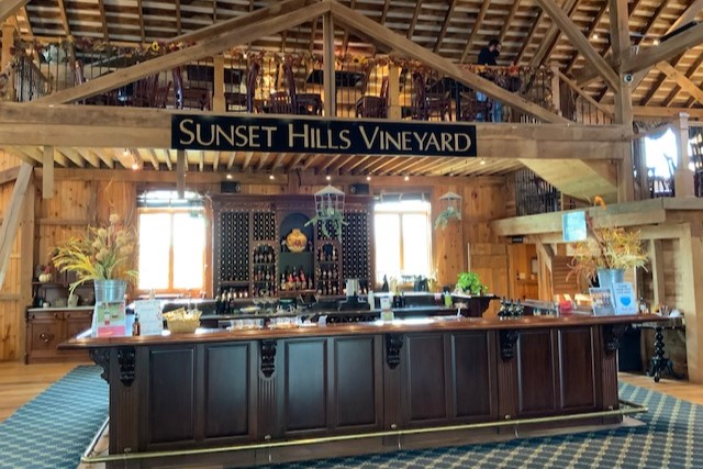 Relax inside Sunset Hills Vineyard’s inviting interior, featuring rustic decor and cozy seating