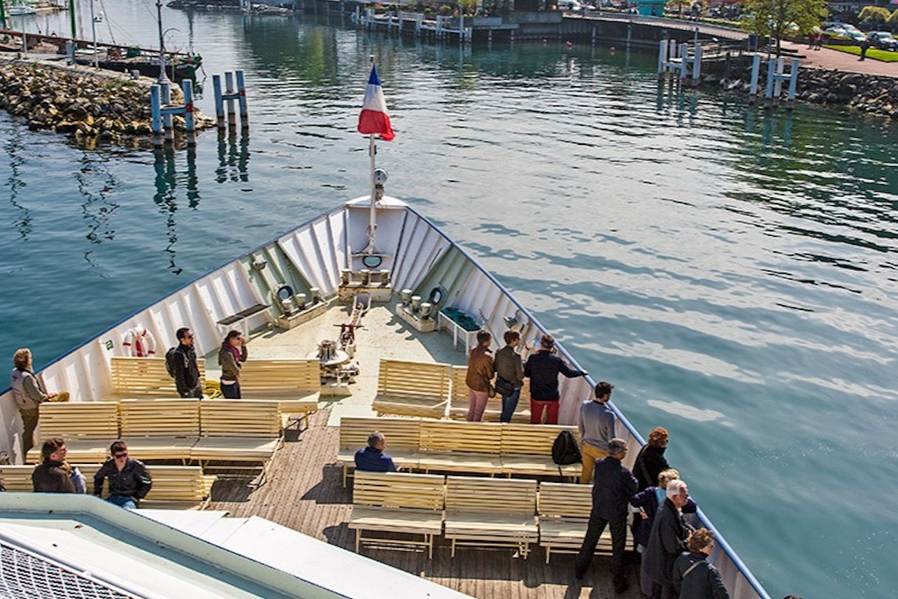 Guests enjoying the view of the sea on the open deck