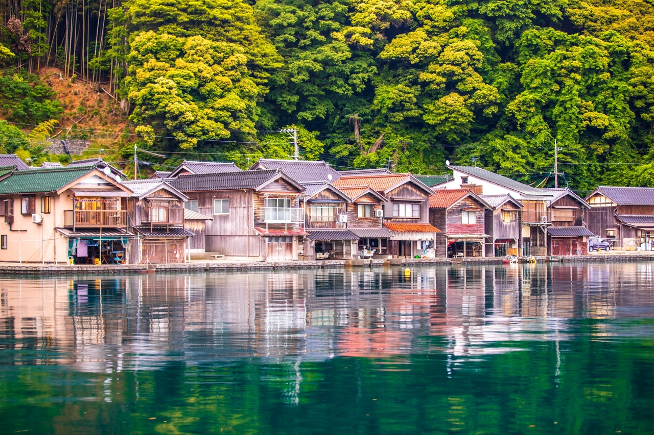 伊根位於京都北部丹後半島,是一座寧靜純樸的海濱漁村,其傳統建築「舟屋」是一大特色。一棟棟貼海而建的舟屋,一樓作為船庫,二樓為居住空間,展現伊根人與海共生的智慧。漫步在舟屋群之間的小徑,彷彿穿梭時光,感受濃厚的漁村人情與自然氣息,讓人沉浸在悠閒緩慢的海岸生活之中。 伊根位於京都北部丹後半島,是一座寧靜純樸的海濱漁村,其傳統建築「舟屋」是一大特色。一棟棟貼海而建的舟屋,一樓作為船庫,二樓為居住空間,展現伊根人與海共生的智慧。漫步在舟屋群之間的小徑,彷彿穿梭時光,感受濃厚的漁村人情與自然氣息,讓人沉浸在悠閒緩慢的海岸生活之中。