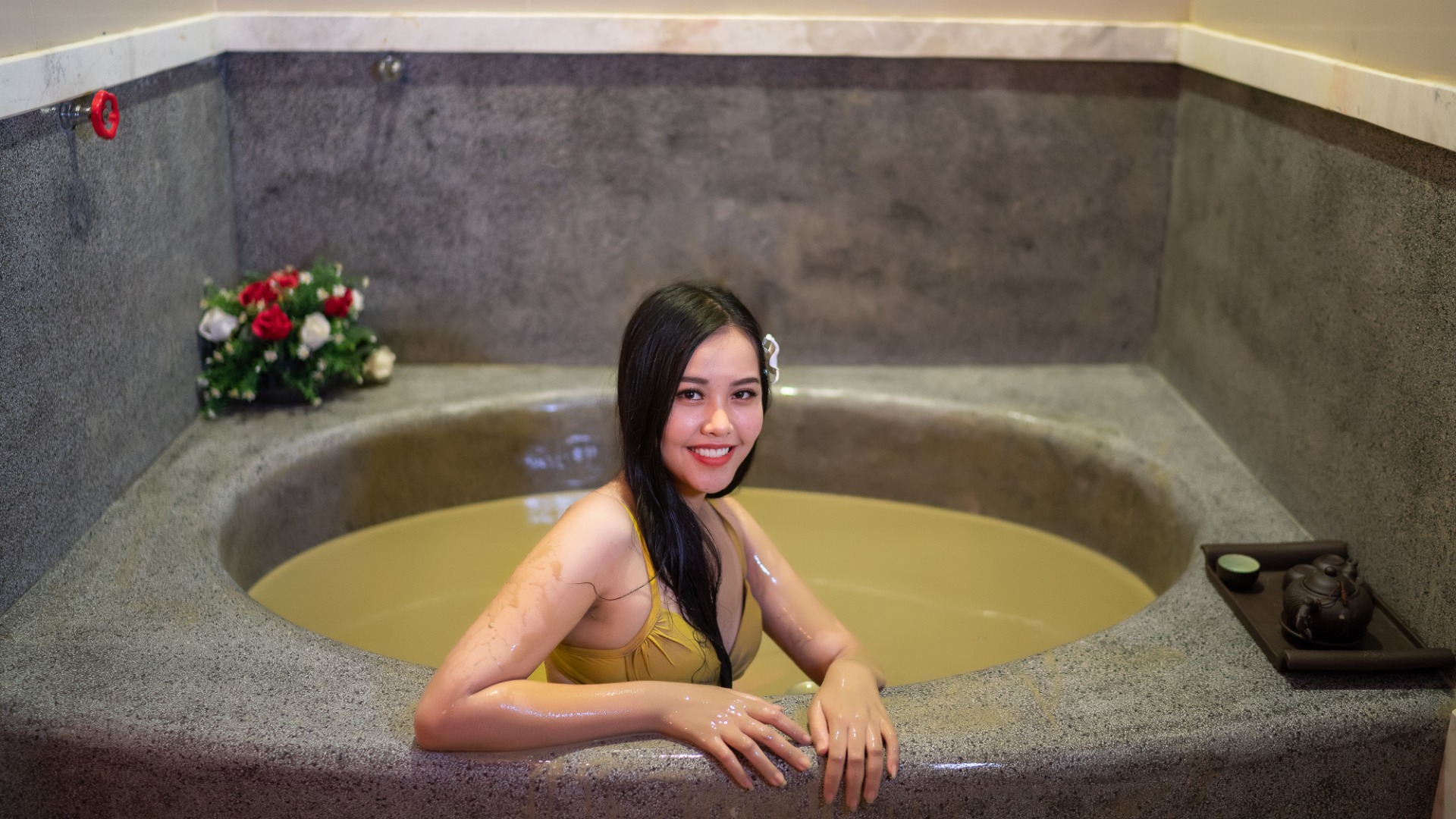 woman mud bathing inside private room of Galina Hotel & Spa