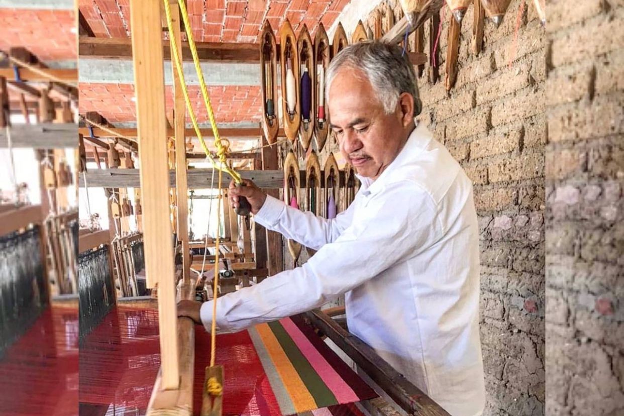Local artisan weaving a vibrant wool rug using natural dyes in Teotitlán