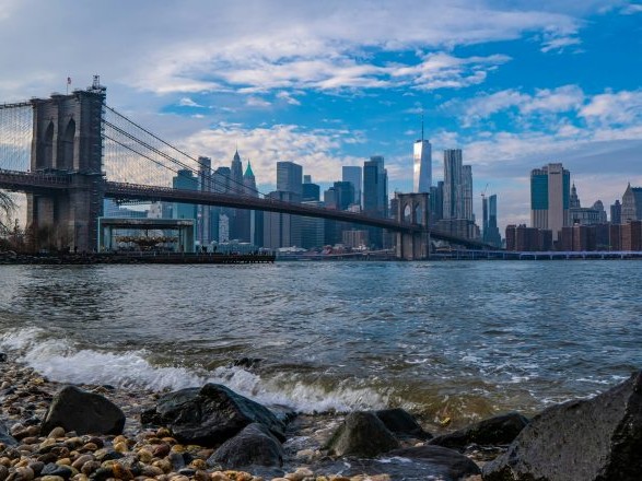 Walk across the Brooklyn Bridge and admire its incredible architecture and skyline