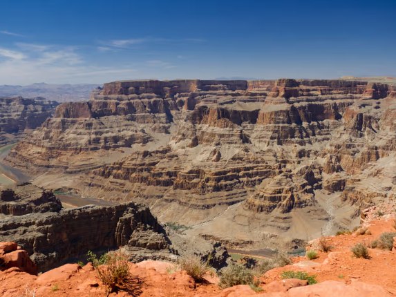 Sweeping desert horizon showcasing the vast Mojave Desert stretching endlessly under a brilliant blue sky