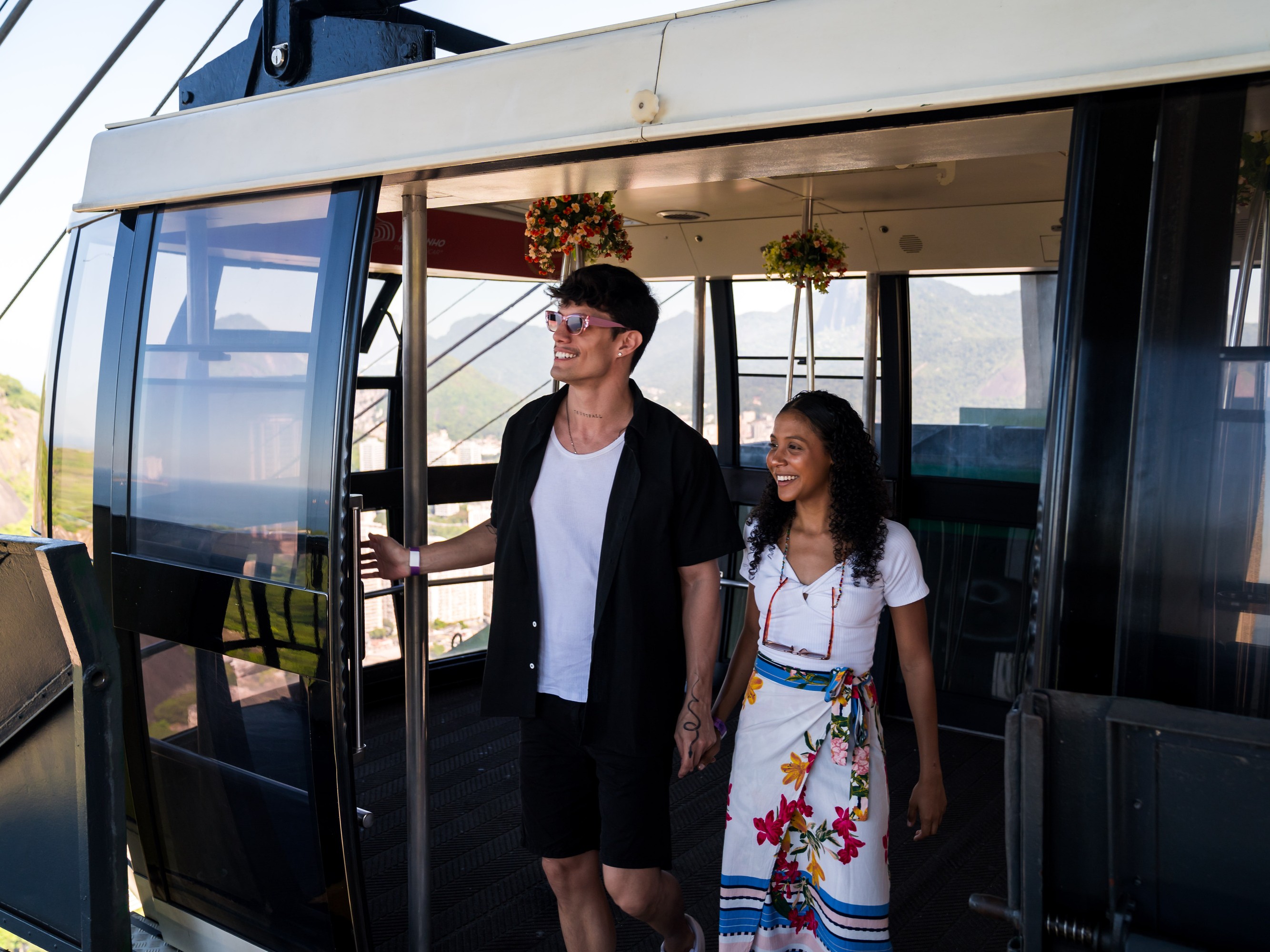 Smiling tourists inside historic Corcovado Train enjoying the peaceful ride through the forest