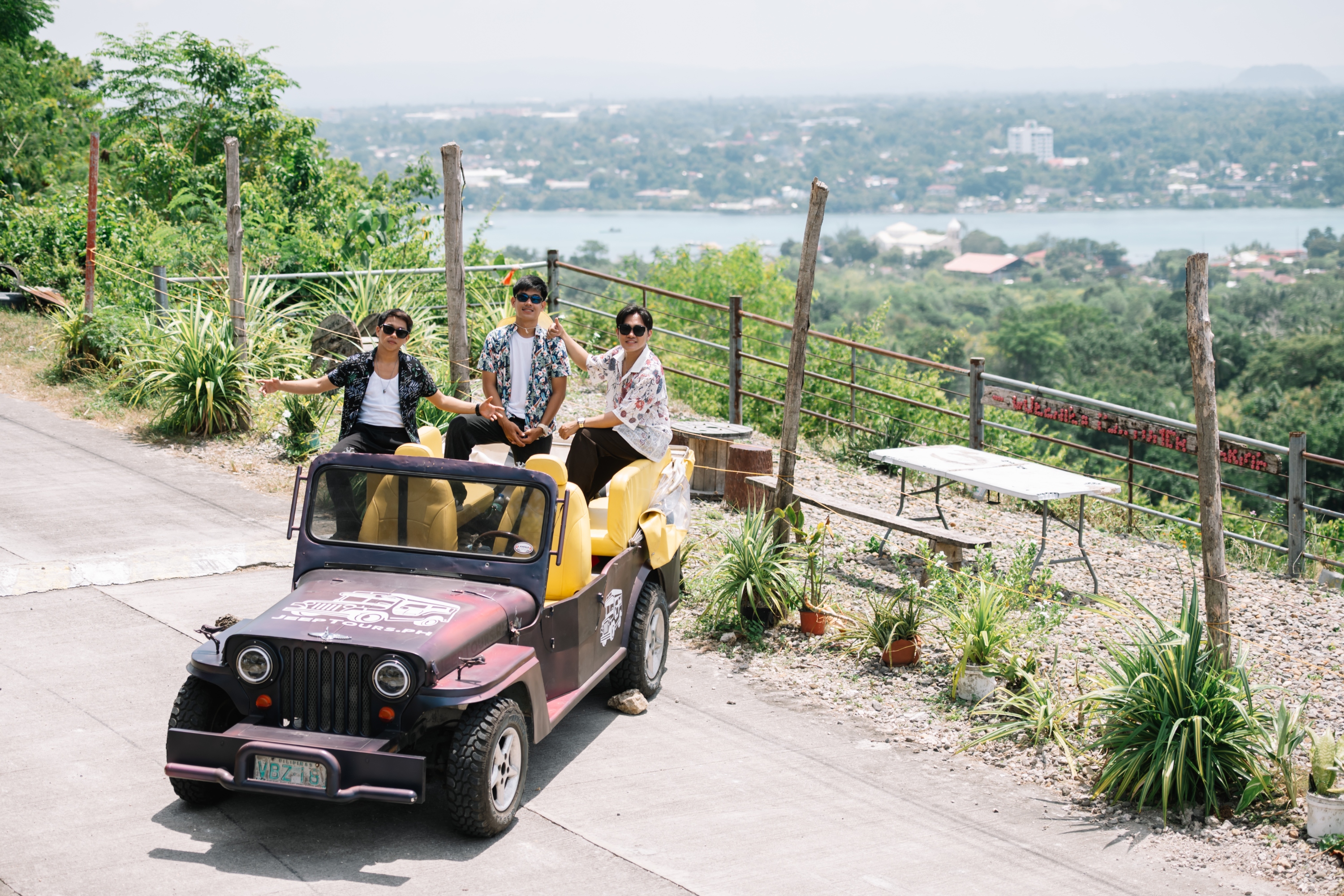 Group of friends enjoying the view while their jeep is parked