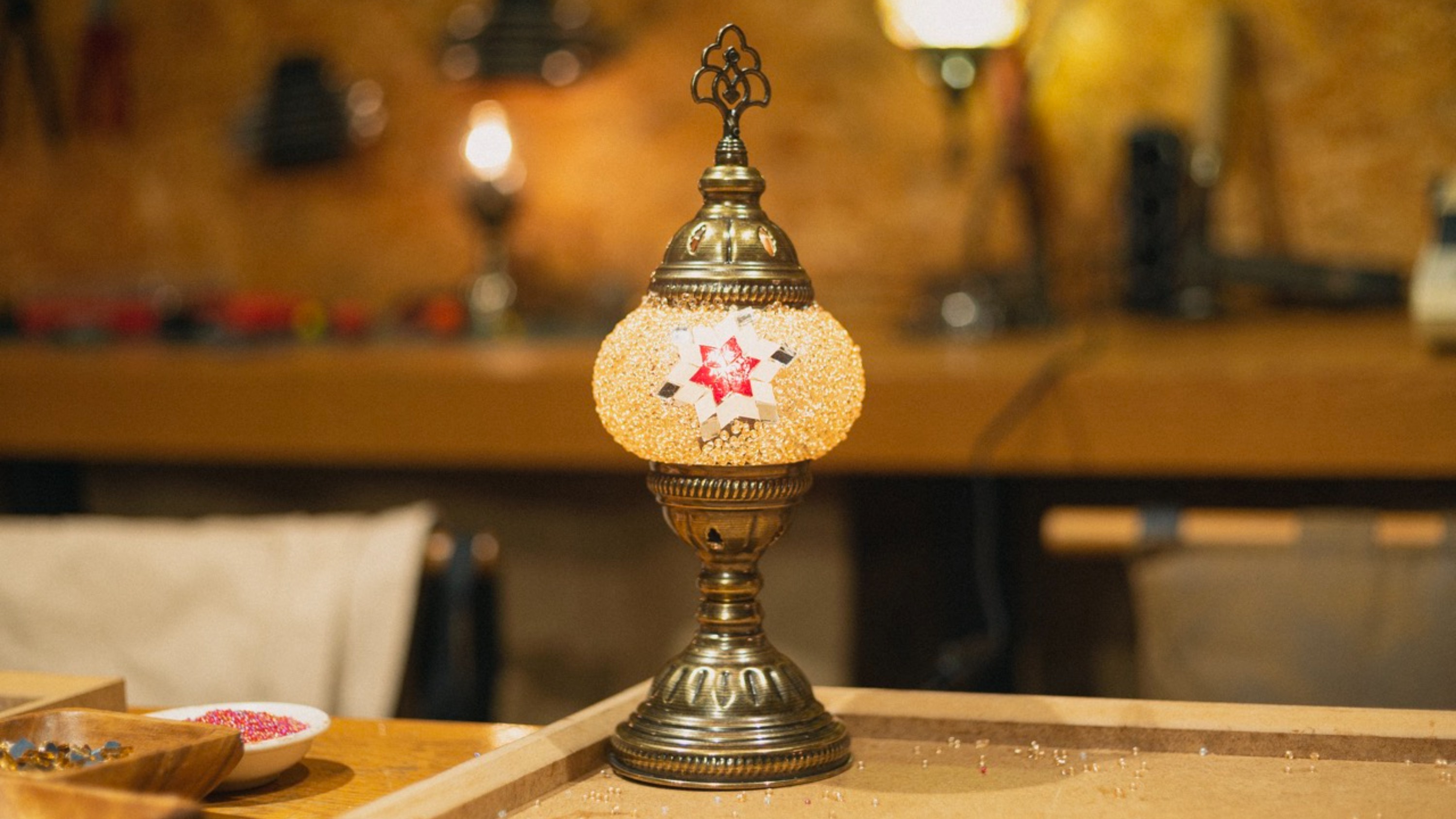 An artisan adds a red star pattern to the lamp's surface, where Turkish tradition meets creative expression