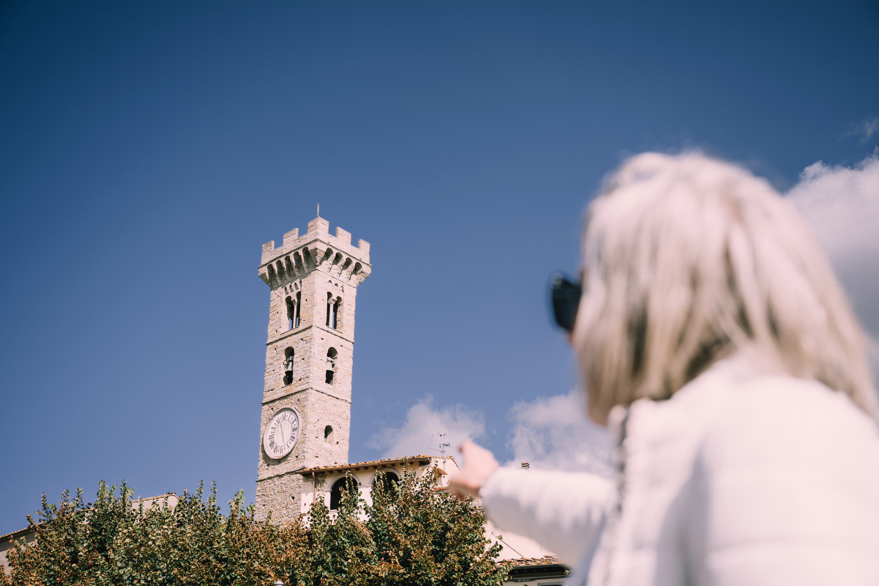 Woman pointing at a tower