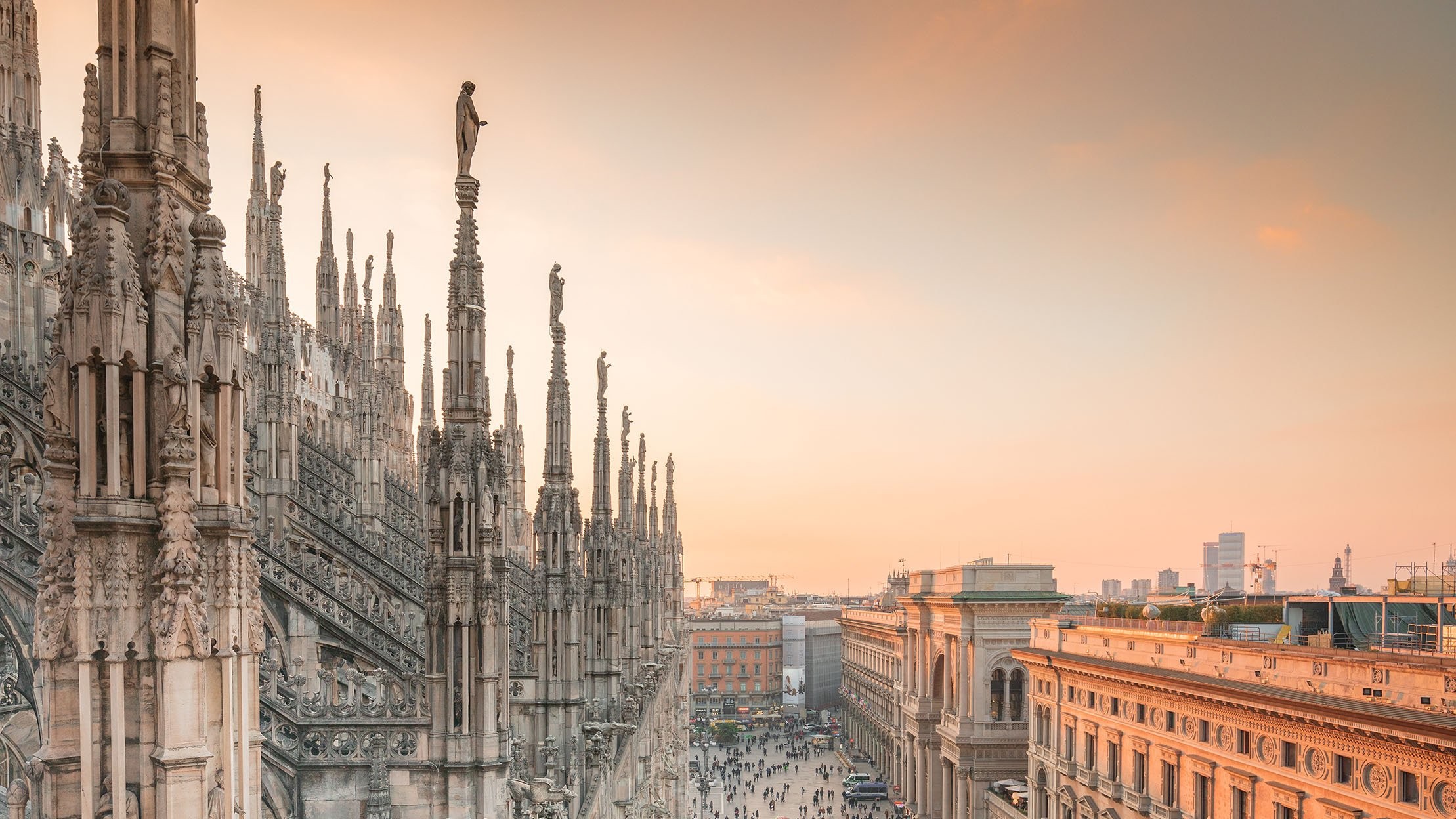 Gothic spires and statues adorn the Duomo, showcasing intricate architectural beauty and craftsmanship