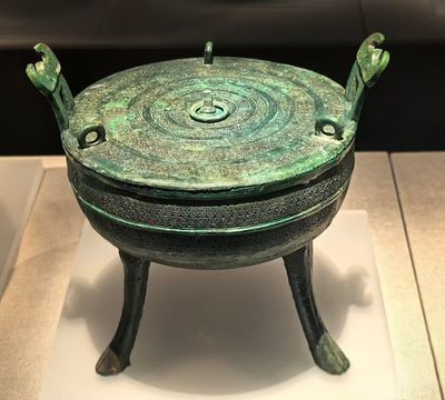 青銅器物呈青綠鏽色,器身滿布回紋等細密紋飾,雙獸形耳配三足,盡顯古器的莊重與先秦工藝的精緻,是博物館中的代表性文物 青銅器物呈青綠鏽色,器身滿布回紋等細密紋飾,雙獸形耳配三足,盡顯古器的莊重與先秦工藝的精緻,是博物館中的代表性文物