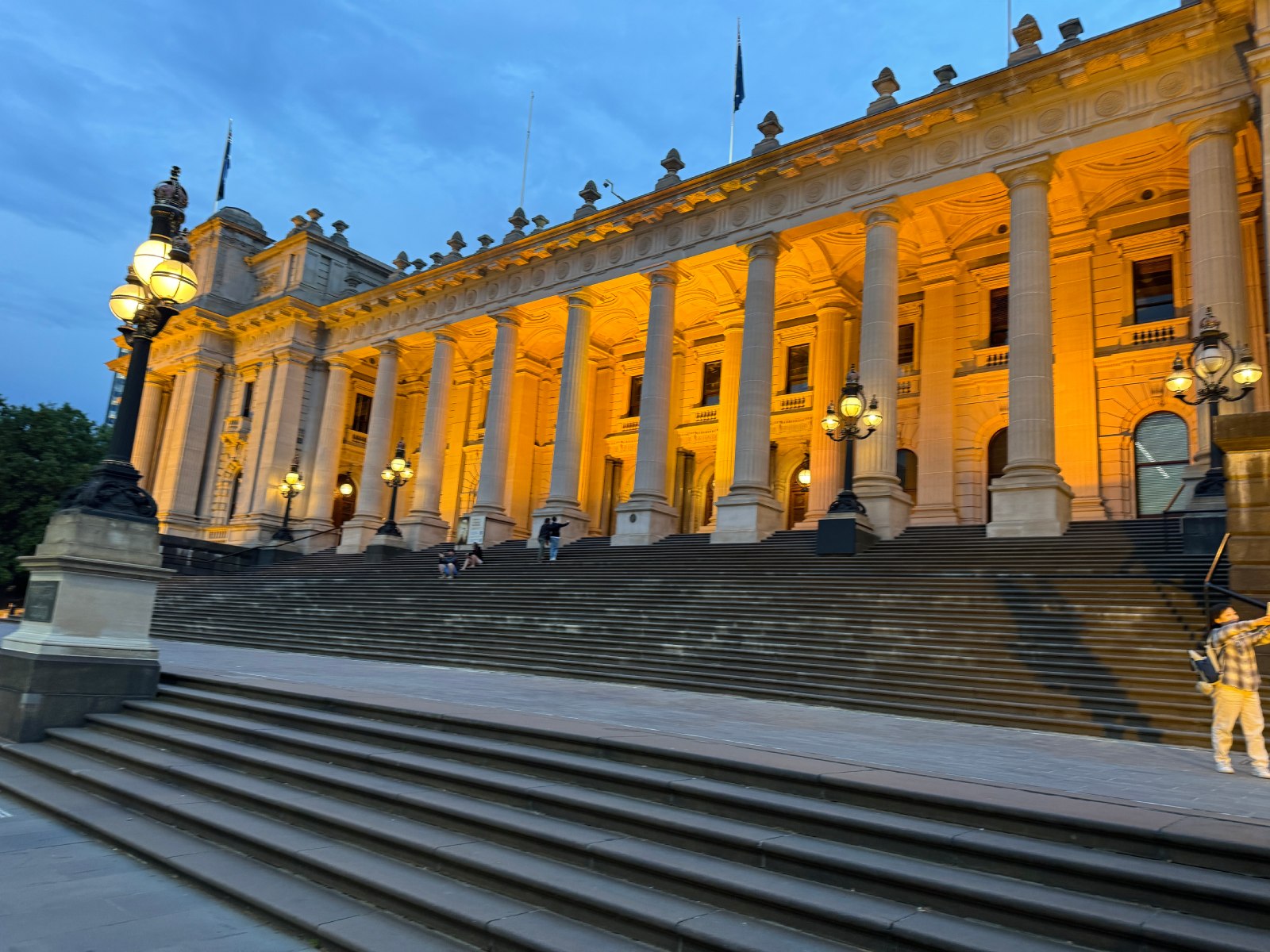 Stand on the steps of history at Melbourne’s grand Parliament House, where power and elegance meet.