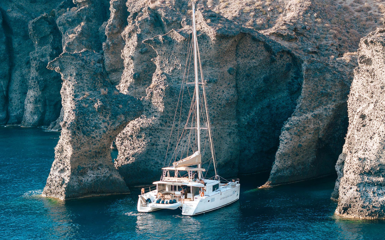 Glide past volcanic cliffs and iconic coastline towards unforgettable golden hour colours