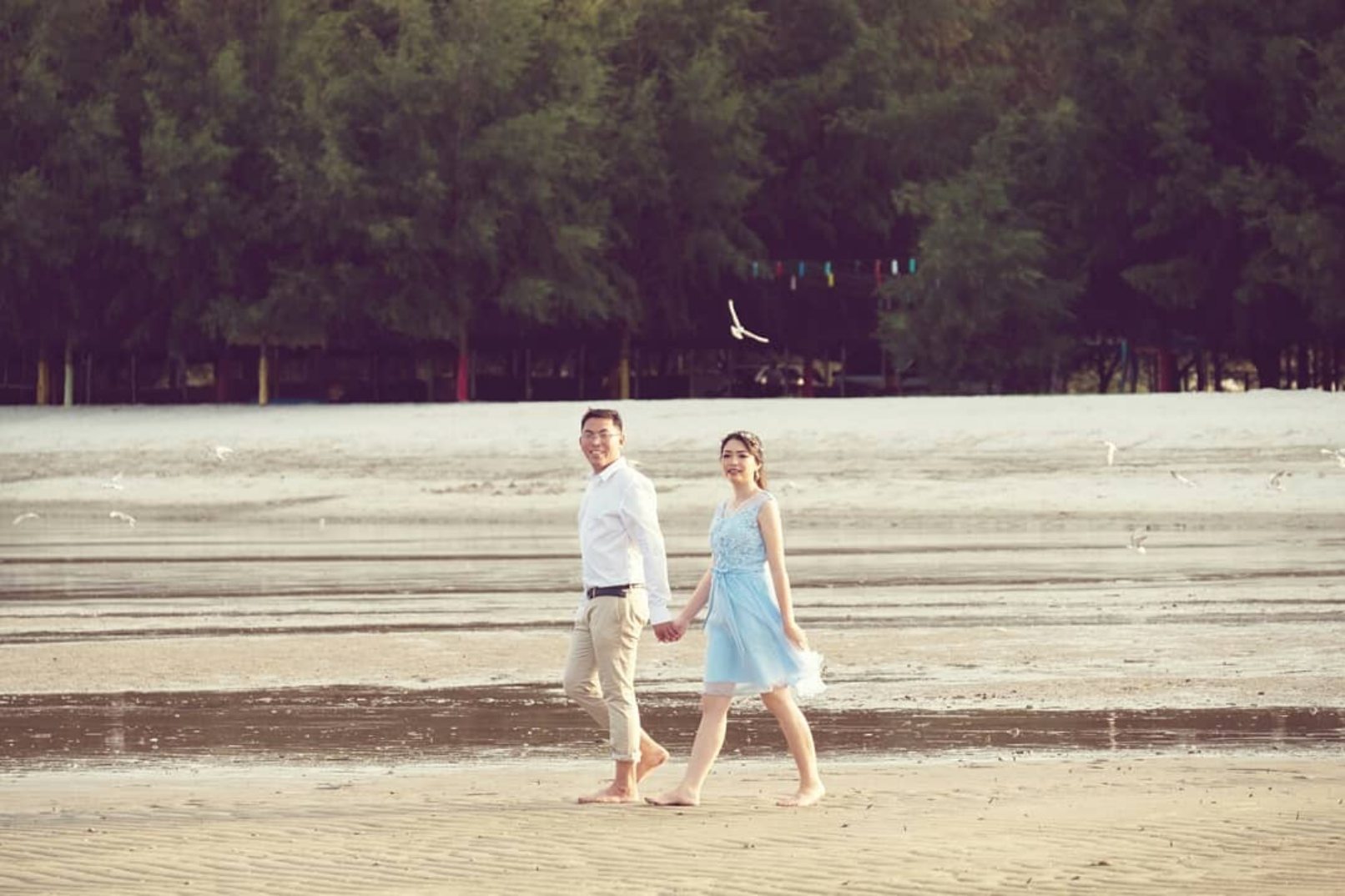 Man and woman walking along beach