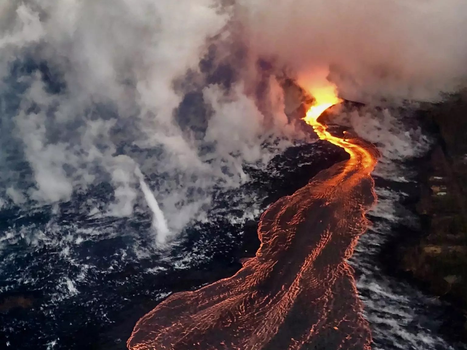 Capture molten lava streams carving paths through Hawaii’s volcanic terrain from above